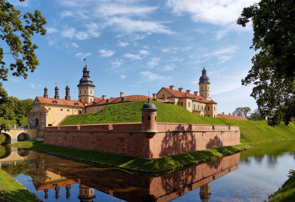 Nesvizh Palace and its moat reflected in still water